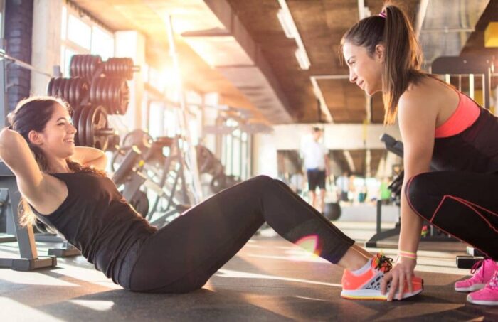 Friends exercising at the gym.