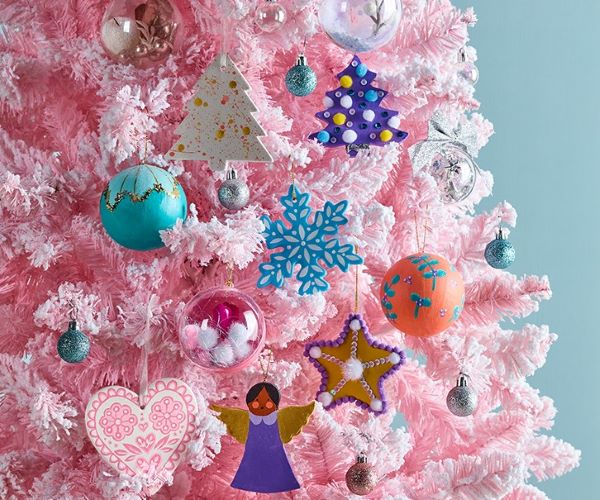 Bright baubles on pink christmas tree.